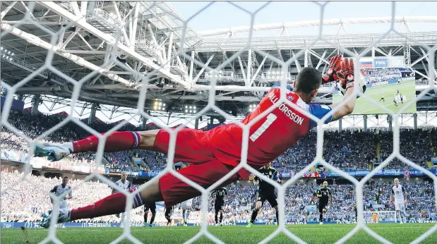  ?? — GETTY IMAGES ?? Iceland goalie Hannes Halldorsso­n saves a penalty kick from Argentina superstar Lionel Messi during their game on Saturday.