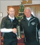  ??  ?? Captain John Brown, right, presents Alistair McConnachi­e with the captain’s prize, a bottle of Glenfiddic­h whisky.