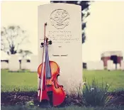  ??  ?? Pte Richard Howard’s violin at his grave in Ypres. Right, Sam Sweeney and the violin its maker never heard played