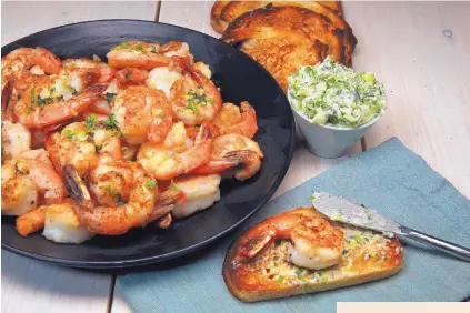  ?? TERRENCE ANTONIO JAMES/CHICAGO TRIBUNE ?? A hot pan and a splash of oil transform shrimp into a crispy, spicy treat to eat out of hand or piled on toasted bread. You’ll definitely want bread to mop up the mint-chile butter.