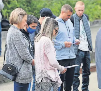  ??  ?? Poignant moment People taking part in the service reflect on their painful losses