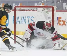  ?? Peter Diana/Post-Gazette ?? Devils goaltender Mackenzie Blackwood makes save on Penguins center Colton Sceviour Sunday at PPG Paints Arena.