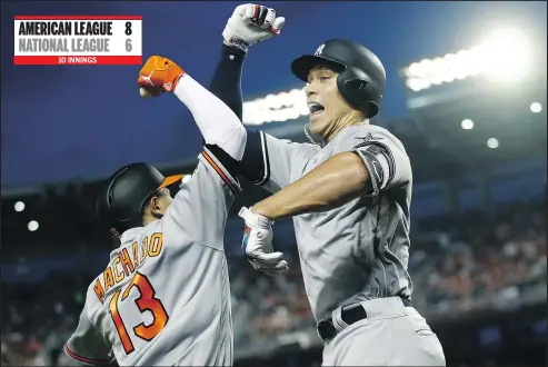  ?? — THE ASSOCIATED PRESS ?? New York Yankees slugger Aaron Judge, right, celebrates his solo home run with Baltimore Orioles shortstop Manny Machado during the first inning at the all-star game in Washington, D.C. on Tuesday night.