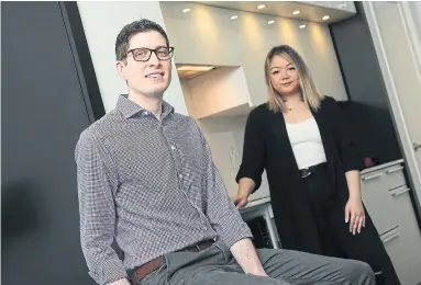  ?? RENÉ JOHNSTON TORONTO STAR ?? First-time homeowner Kyle Paranuik with his agent, Connie Truong, in his new Toronto condo. While he was a university student, Paranuik set the goal of owning his own home and started saving when he got his first job back in 2010.