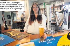 ??  ?? Screen test... manager Laura Jones serves a pint from behind perspex at the Organ pub in Stalybridg­e