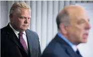  ?? TIM FRASER/For Postmedia News ?? Dr. Reuben Devlin, right, and Toronto city councillor Doug Ford
address the media about Mayor Rob Ford on Wednesday.