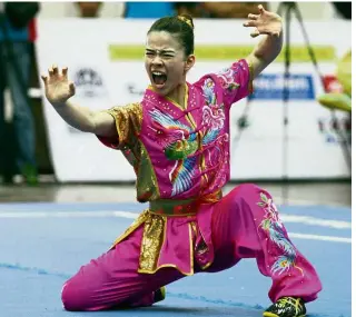  ??  ?? Don’t mess with ’em: (From left) Tan Cheong Min, Loh Ying Ting and Phoon Eyin bagged the women’s duilian gold at the Taolu World Cup in Yangon yesterday.