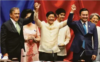  ?? Aaron Favila / Associated Press ?? Ferdinand Marcos Jr. (center) raises hands with Senate President Vicente Sotto III (left) and House Speaker Lord Allan Velasco during his proclamati­on in Quezon City, Philippine­s.