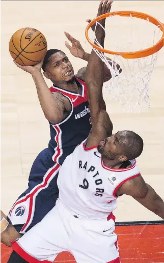  ?? NATHAN DENETTE/THE CANADIAN PRESS ?? Toronto Raptors forward Serge Ibaka, pictured defending Washington’s Bradley Beal in Game 1 of their playoff series, has become an integral part of the Raptors’ success story this season, and recorded a team-high 23 points in their opening game victory in Toronto Saturday.