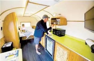  ?? FOR THE LOS ANGELES TIMES DANIEL A. ANDERSON ?? Janet and Pat Hoy of Morro Bay explore their vintage trailer on check-in at the Waypoint vintage trailer park in Ventura, where units range from 1940s trailers to modernized Airstreams.