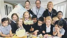  ?? ?? Staff and pupils from Orton Wistow primary tasting their potatoes