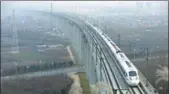  ?? YUAN JINGZHI / FOR CHINA DAILY ?? A bullet train heading from Chengdu in Sichuan province to Xi’an, Shaanxi province, passes through the Qinling Mountains area on Wednesday.