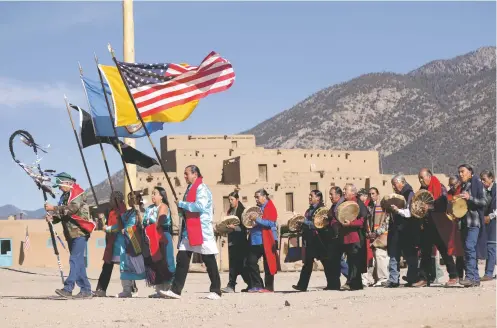  ?? JESSE MOYA/TAOS NEWS ?? Members of Taos Pueblo’s Veterans Day procession make their annual walk around the pueblo Monday, honoring veterans past and present.