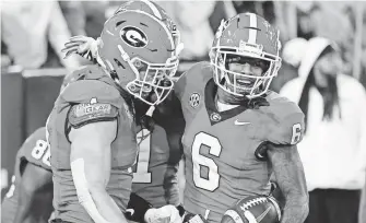  ?? JOSHUA L. JONES/ATHENS BANNER-HERALD ?? Georgia wide receiver Dominic Lovett (6) celebrates with his teammates after scoring a touchdown against Georgia Tech.