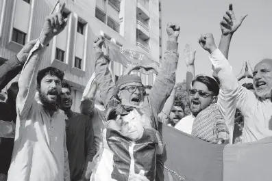  ?? AP ?? Supporters of Pakistan’s former Prime Minister Imran Khan’s party, Pakistan Tehreek-e-Insaf, chant slogans during a protest against alleged vote-rigging in some constituen­cies in the parliament­ary elections in Karachi on Sunday.