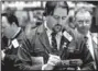  ??  ?? Michael Mozian with Global Direct Equities works the trading floor of the New York Stock Exchange on Thursday.