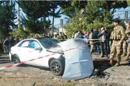  ?? MAHMOUD ZAYYAT/GETTY-AFP ?? Bloodstain­s cover the ground next to a battered vehicle Saturday after an Israeli drone strike near Lebanon’s coastal town of Jadra. Two people were killed.