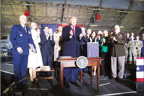  ?? (AP) ?? US President Donald Trump applauds after signing the National Defense Authorizat­ion Act for Fiscal Year 2020 at Andrews Air Force Base, Md on Dec 20 before
traveling to Mar-a-lago in Palm Beach, Florida.