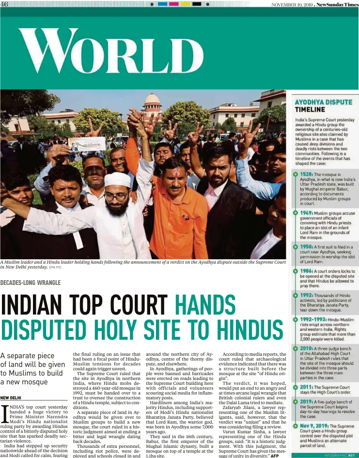  ?? EPA PIC ?? A Muslim leader and a Hindu leader holding hands following the announceme­nt of a verdict on the Ayodhya dispute outside the Supreme Court in New Delhi yesterday.