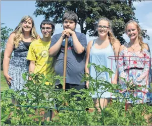  ?? ERIC MCCARTHY/JOURNAL PIONEER ?? Project co-ordinator Jenna MacDonald, left, joins participan­ts in a Good Food, Good Health – Westisle Garden Project on a tour of their garden. Participan­ts are Brendon Bulger, Jacob Gallant, Drew McInnis and Shannon Watters.