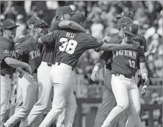  ?? NATI HARNIK/AP PHOTO ?? LSU players celebrate with closer Zack Hess (38) after the last out in Saturday’s 6-1 win over Oregon State in the College World Series at Omaha, Neb.