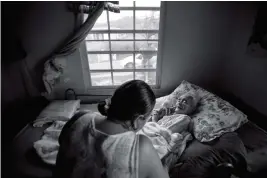  ?? ASSOCIATED PRESS PHOTOS ?? IN THIS DEC. 21 PHOTO, SIX-YEAR-OLD MELANIE OLIVERAS GONZALEZ HOLDS A LANTERN IN THE LIVING ROOM of her house in Sector Padre Ibanes, in Morovis, Puerto Rico. All electronic­s are connected at night to an inverter plugged to the family car battery. In...