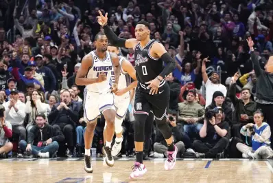  ?? (AP Photo/mark J. Terrill) ?? Los Angeles Clippers guard Russell Westbrook, right, celebrates after scoring as Sacramento Kings forward Harrison Barnes runs behind Friday during the second half of an NBA basketball game in Los Angeles.
