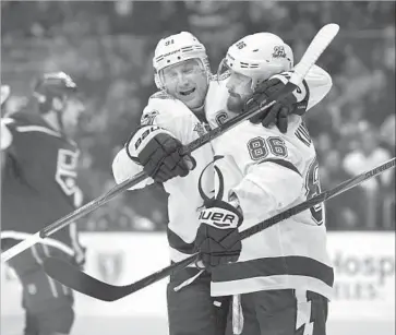  ?? Michael Owen Baker Associated Press ?? TAMPA BAY’S Nikita Kucherov, right, gets a hug from Steven Stamkos after giving the Lightning a 1-0 lead.