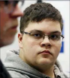  ?? STEVE HELBER — THE ASSOCIATED PRESS FILE ?? In this file photo, Gloucester County High School senior Gavin Grimm, a transgende­r student, listens to a speaker during a news conference in Richmond, Va. Grimm is continuing to sue the Gloucester County School Board in Virginia over a policy that banned him from using the boys’ bathrooms. He’s now trying to amend the suit to include the matter of his unchanged transcript­s.