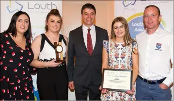  ??  ?? Gerry Murphy Met Éireann presents Jess Myles winner of the Louth PPN Community &amp; Voluntary Awards 2018 in Sports with members of the Ardee Rugby Club.