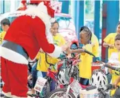  ?? JENNIFER LETT/SUN SENTINEL ?? Last year, Santa Claus greets members of the Boys & Girls Club during the Rick Case Bikes for Kids event that provides bikes to children during the holidays at Rick Case Kia in Sunrise.