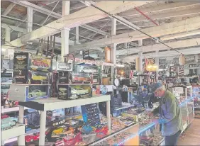  ?? DANIEL DRAINVILLE/THE DAY ?? Frank Ramanski Jr., 65, of Niantic, stands next to his collection of model vehicles.