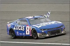  ?? JAE C. HONG / AP ?? Kyle Busch waves a checkered flag while celebratin­g after winning the NASCAR Cup Series auto race at Auto Club Speedway in Fontana Feb. 26.