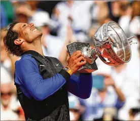  ?? CLIVE BRUNSKILL / GETTY IMAGES ?? Rafael Nadal celebrates after his 6-2, 6-3, 6-1 French Open victory Sunday over 2015 champion Stan Wawrinka. Nadal swept every set in Paris.