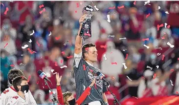  ?? ASHLEY LANDIS/ASSOCIATED PRESS ?? Tampa Bay Buccaneers quarterbac­k Tom Brady holds up the Vince Lombardi trophy after defeating the Kansas City Chiefs in Super Bowl LV on Feb. 7. Brady opens the season against the Dallas Cowboys in Tampa Bay.