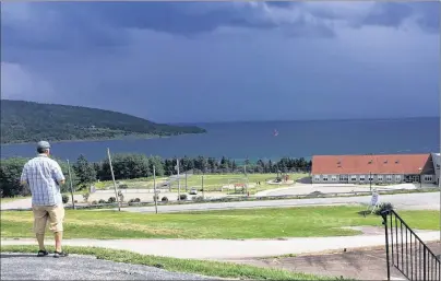  ?? SUBMITTED PHOTO/RANNIE GILLIS ?? The Rankin School of the Narrows is shown in the foreground with the rapidly approachin­g thundersto­rm on the “Big Lake.”