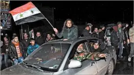  ?? GEORGE OURFALIAN/GETTY-AFP ?? Syrians celebrate Thursday in Aleppo after the army said it had retaken full control.