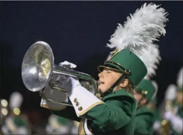  ?? ERIC BONZAR — THE MORNING JOURNAL ?? Sophomore mellophone player Maddie Lewis performs Sept. 15, with the Amherst High School Marching Comets during a road football game against the Midview Middies.