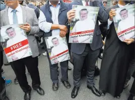  ?? Lefteris Pitarakis ?? The Associated Press Members of the Turkish-arab journalist associatio­n hold posters Monday with photos of missing Saudi writer Jamal Khashoggi during a protest near the Saudi consulate in Istanbul.