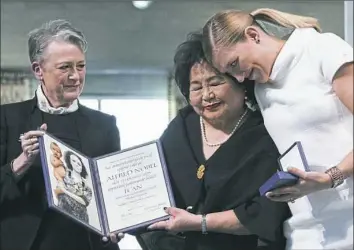  ?? Berit Roald/NTB Scanpix via AP ?? Leader of the Nobel committee Berit Reiss-Andersen, left, presents the Nobel Peace Prize 2017 to Hiroshima survivor Setsuko Thurlow. At right is Beatrice Fihn, leader of the Internatio­nal Campaign to Abolish Nuclear Weapons.