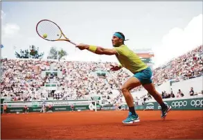  ?? Adam Pretty / Getty Images ?? Rafael Nadal plays a forehand against Botic Van De Zandschulp during the third round at the French Open on Friday.