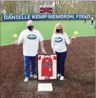 ?? Peter Hvizdak / Hearst Connecticu­t Media ?? Cliff and Melinda Kemp, the parents of Foran softball player Danielle “Danni” Kemp, who lost her battle with cancer at 19, pose with her jersey at the newly dedicated Danielle Kemp Memorial Softball Field.