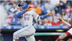  ??  ?? PHILADELPH­IA: New York Mets’ Yoenis Cespedes follows through on a three-run home run off Philadelph­ia Phillies starting pitcher Clay Buchholz during the first inning of a baseball game, Tuesday, in Philadelph­ia. — AP