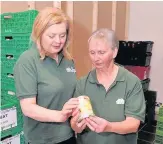  ??  ?? Volunteers Andrea Thomson and Isobel Graham check the dates on the produce