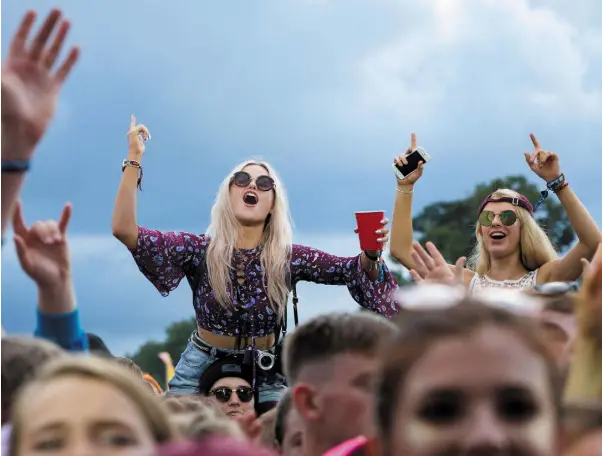  ??  ?? FESTIVAL: Revellers enjoy a break between the rain showers at Electric Picnic in Stradbally, Co Laois. Photo: Fergal Phillips