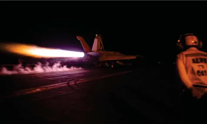  ?? ?? A fighter jet takes off from the USS Dwight D Eisenhower on Saturday night during airstrikes against Houthi targets in Yemen. Photograph: US Navy/Reuters