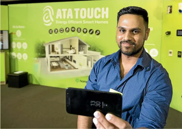  ?? CHRISTEL YARDLEY/STUFF ?? People can also use a controller in their home to set their energy preference­s, says Ata Touch technical sales manager Nish Mambatta at the Waikato Home &amp; Garden Show.