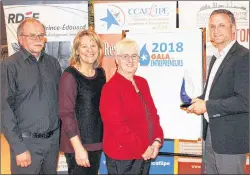  ?? SUBMITTED PHOTO ?? Pierre Gallant, right, spokespers­on for the Acadian and Francophon­e Chamber of Commerce of P.E.I., teases three of the finalists from the Chamber’s business award with one of the championsh­ip trophies. From left are finalists Alcide Bernard, president...