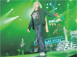  ?? TRIBUNE NEWS SERVICE ?? Joe Elliott on stage with Def Leppard in London in 2015.