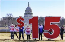  ?? J. SCOTT APPLEWHITE — THE ASSOCIATED PRESS ?? Activists appeal for a $15 minimum wage near the Capitol in Washington, Thursday, Feb. 25. The $1.9 trillion COVID-19 relief bill being prepped in Congress includes a provision that over five years would hike the federal minimum wage to $15 an hour.